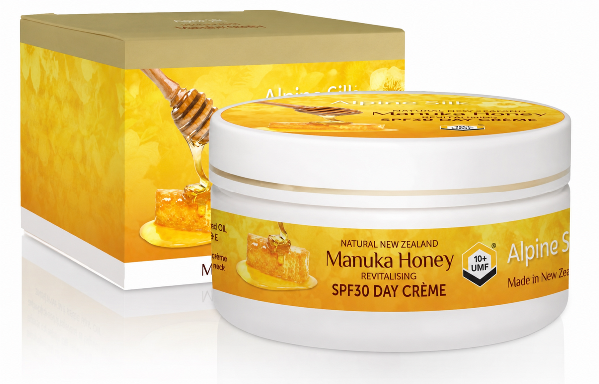 A jar of Manuka Honey Revitalising SPF30 Day Creme alongside its packaging box, both featuring a golden-yellow and white design with illustrations of honeycomb and a honey dipper.